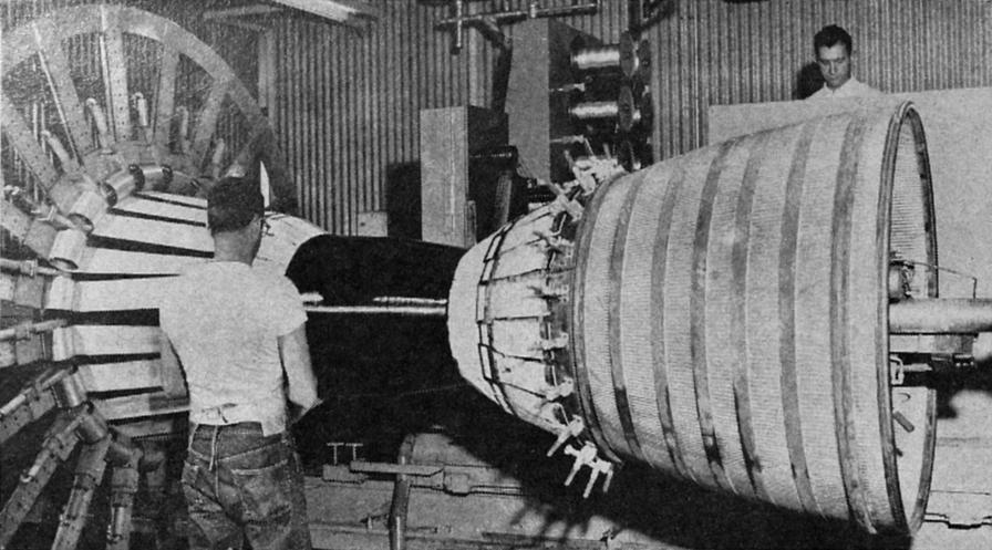 FIBER GLASS WRAPPING applied to the thrust chamber of Atlas MA-3 engines replaces heavy steel bands, reducing weight but keeping same strength as steel.